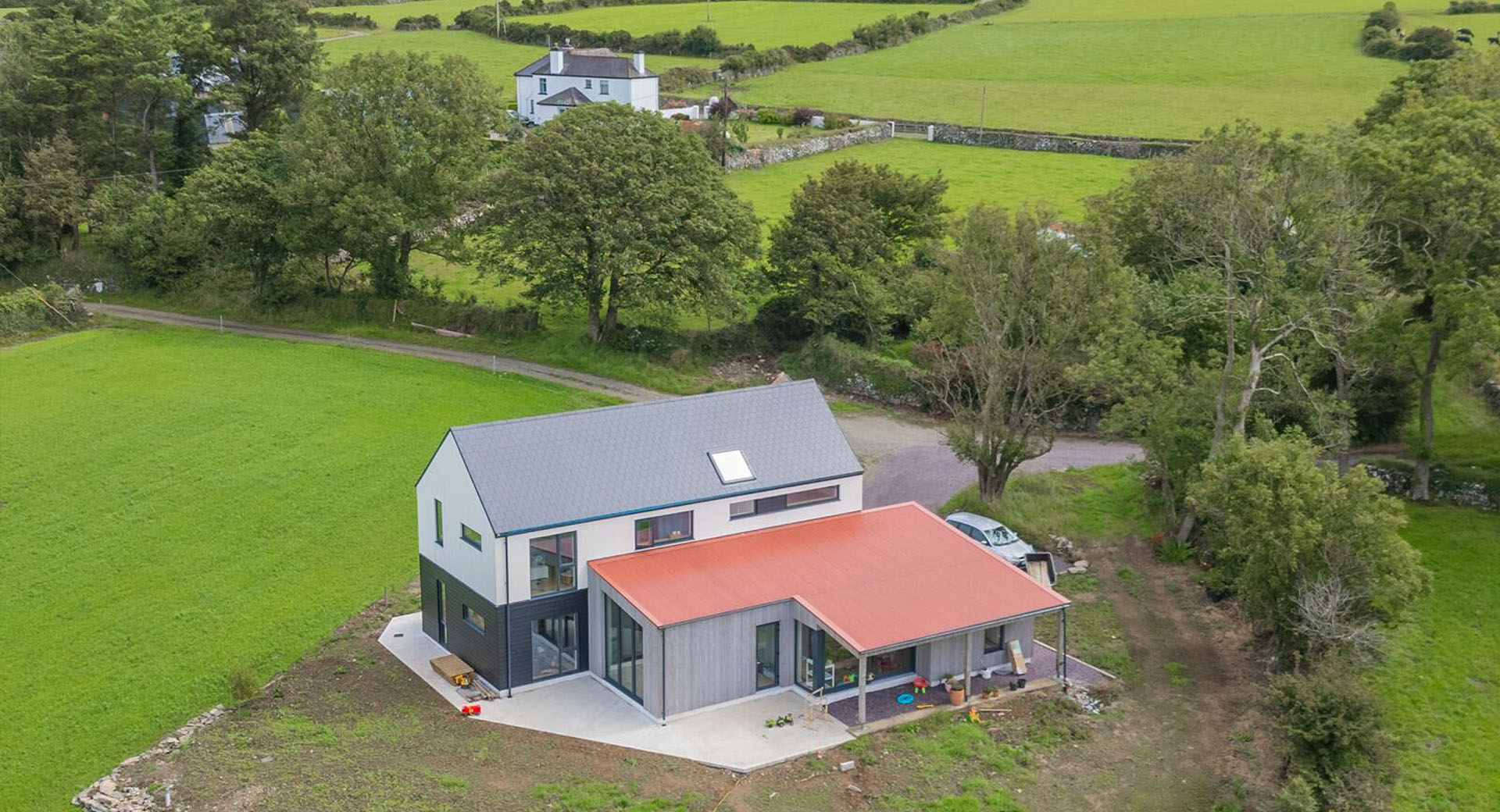 Drone shot of farmhouse with fields behind