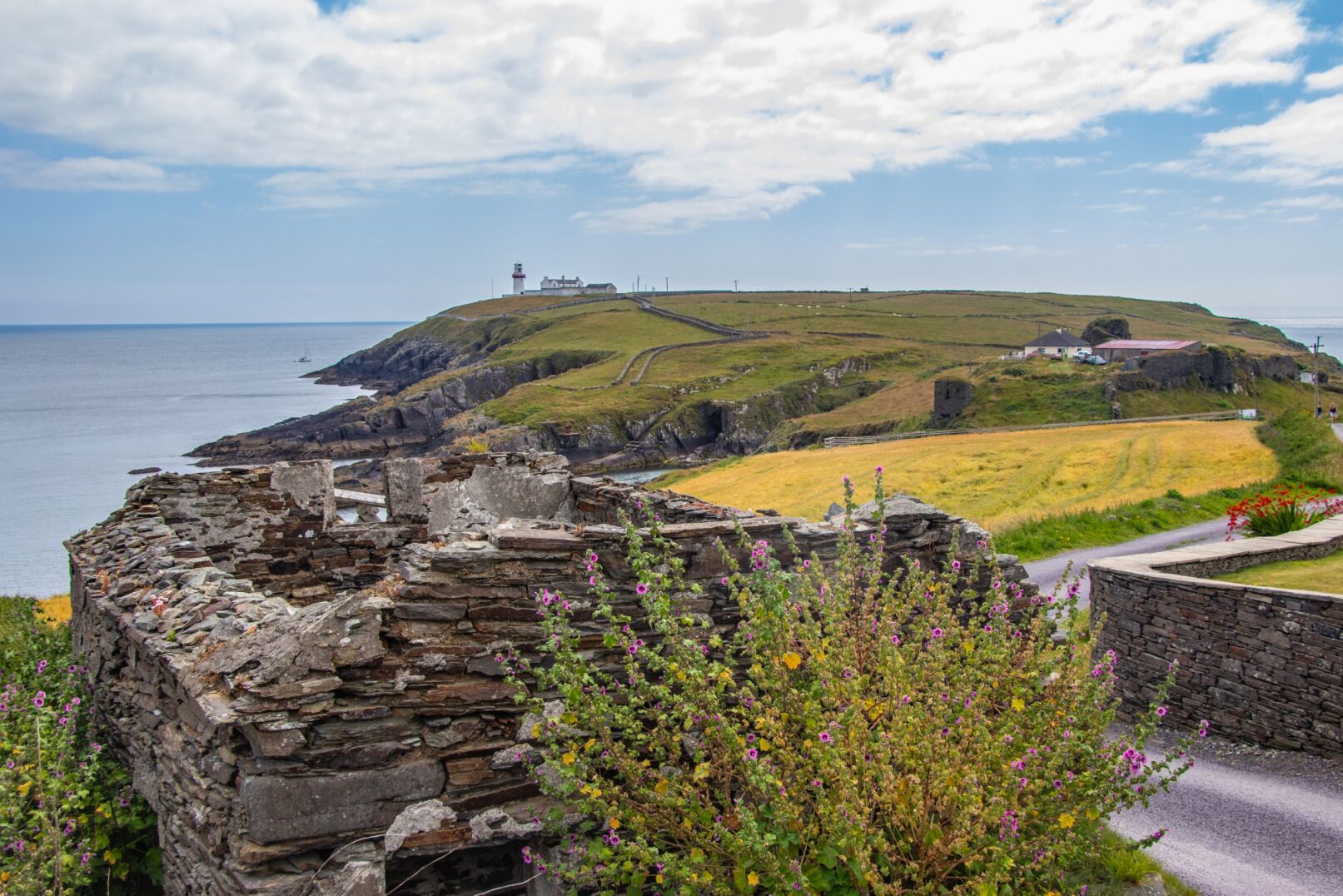 Lighthouse with wall and road in foreground
