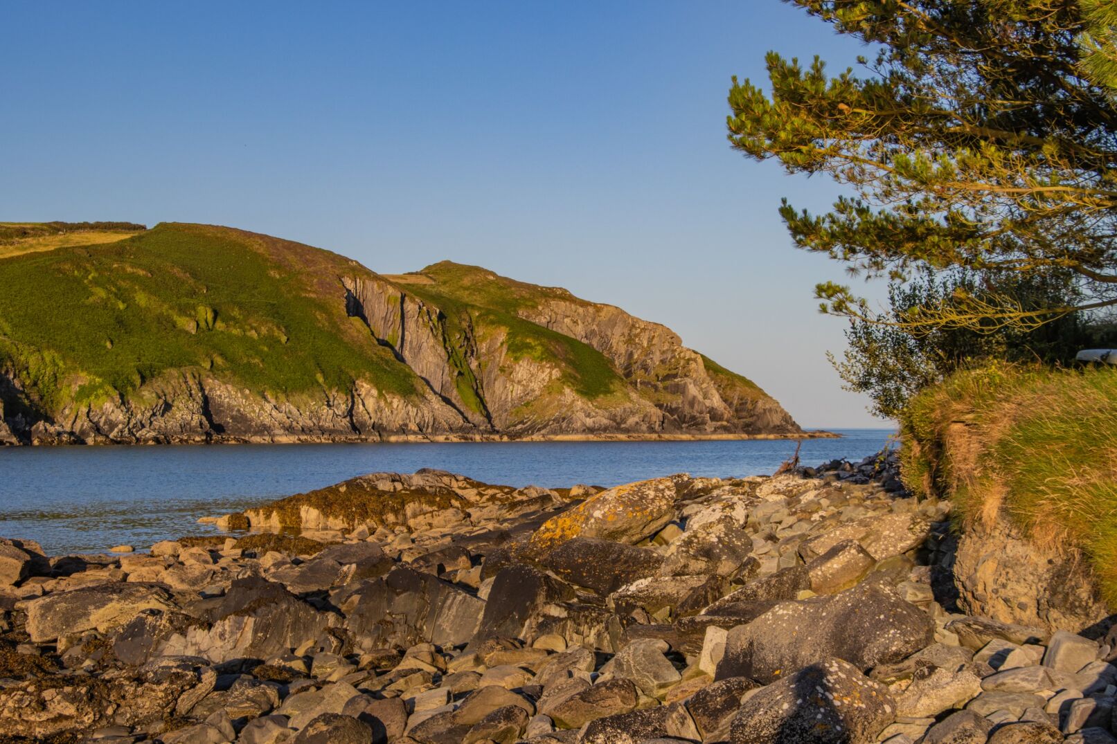 View of rocks and rugged hills behind river