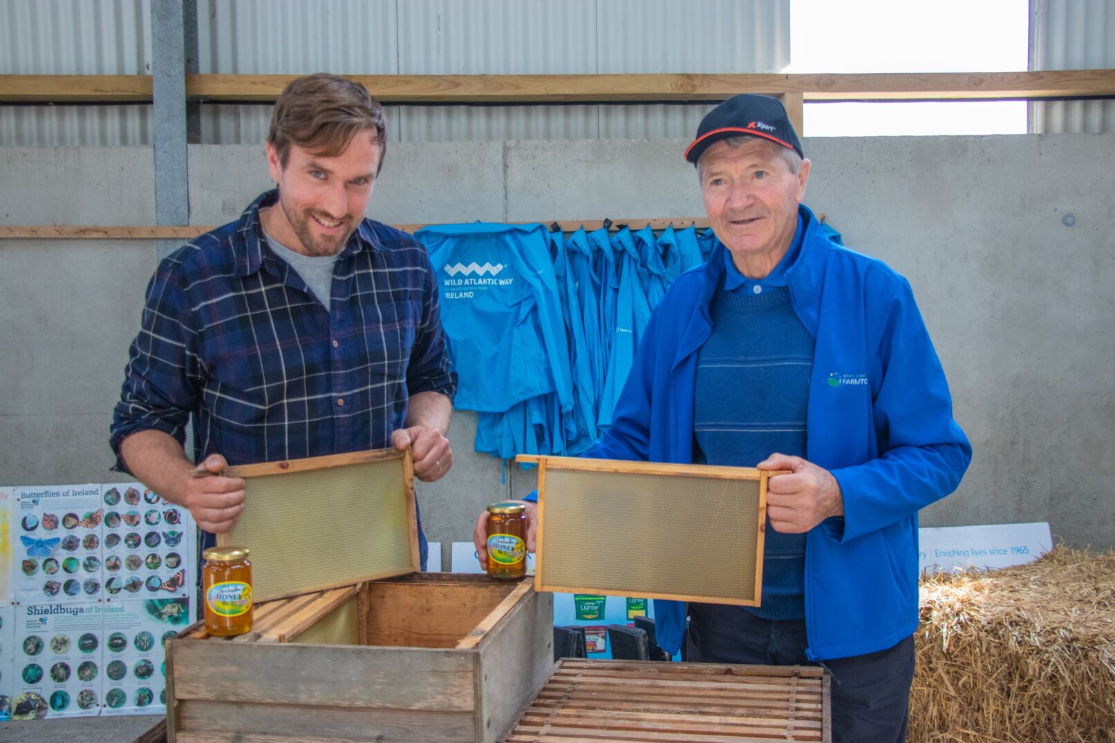 Father and son farmers - John Joe & Andrew O’Sullivan - demonstrating beehive in shed