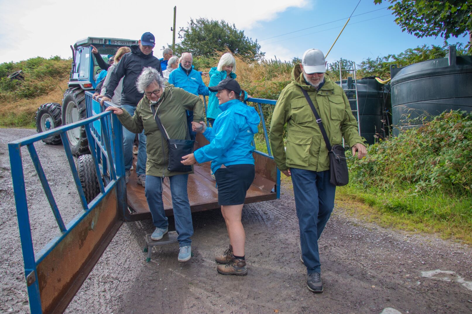 Visitors disembarking from tractor trailer